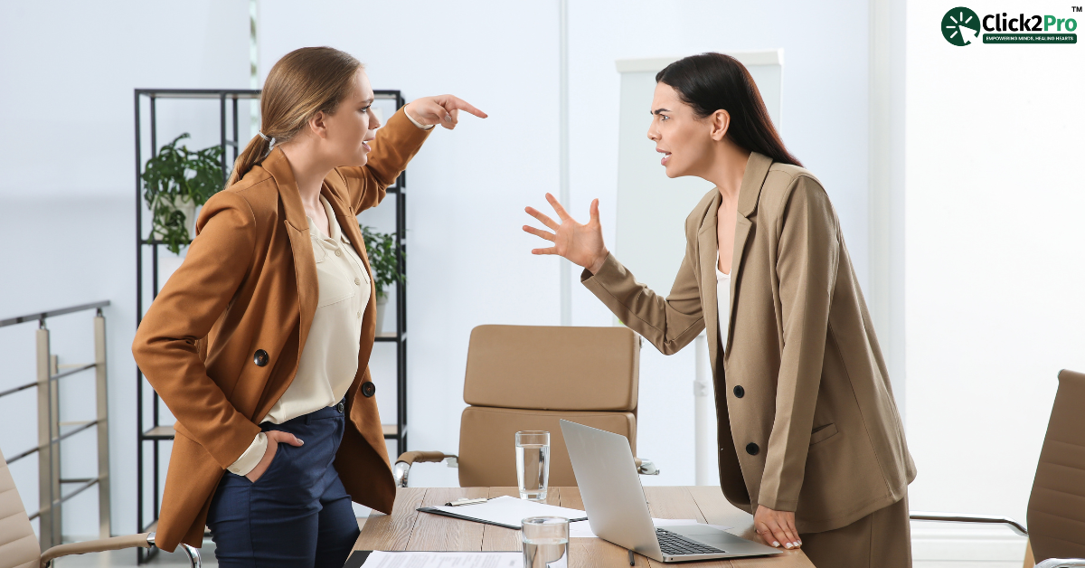 Two women in a heated discussion, illustrating emotional abuse in workplace, relevant to counselling.
