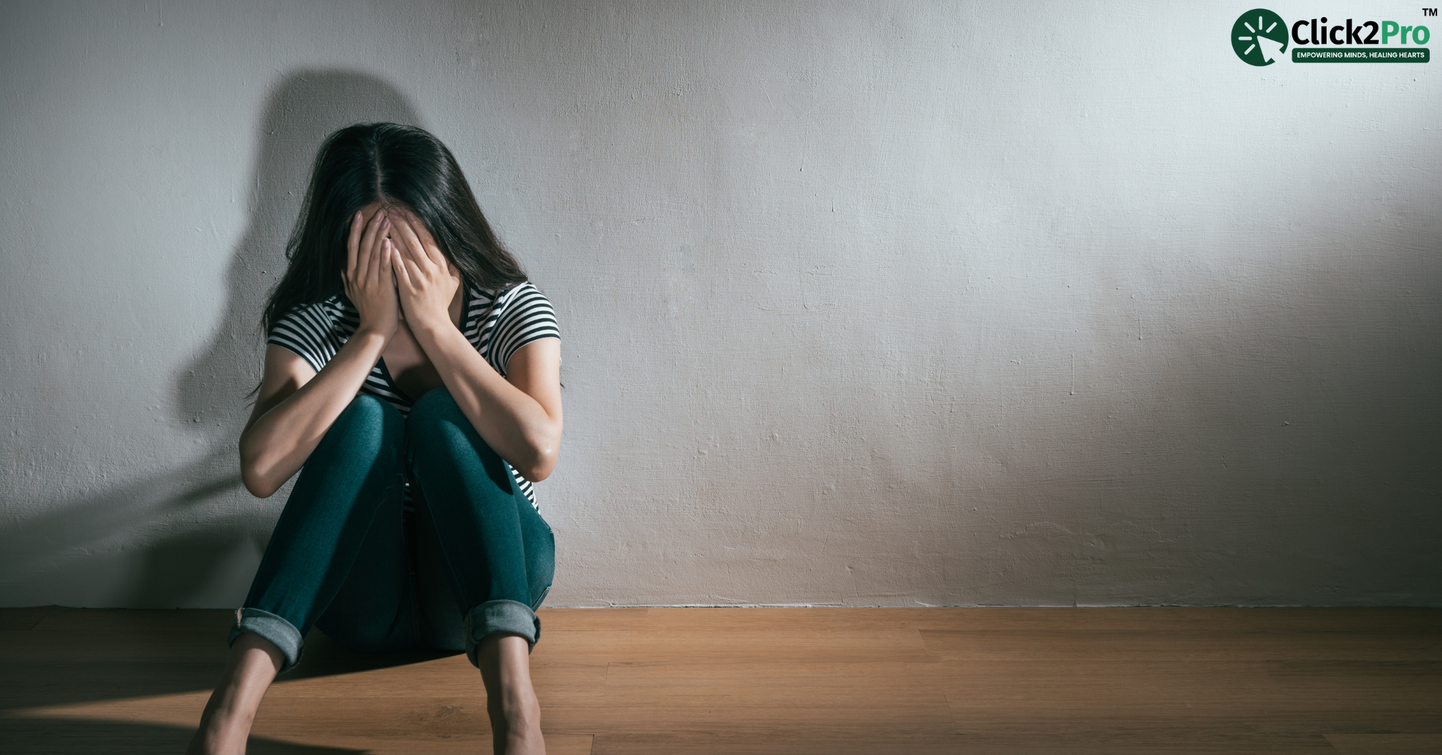 Depressed woman sitting alone in a room, seeking mental health Counselling and therapy support.