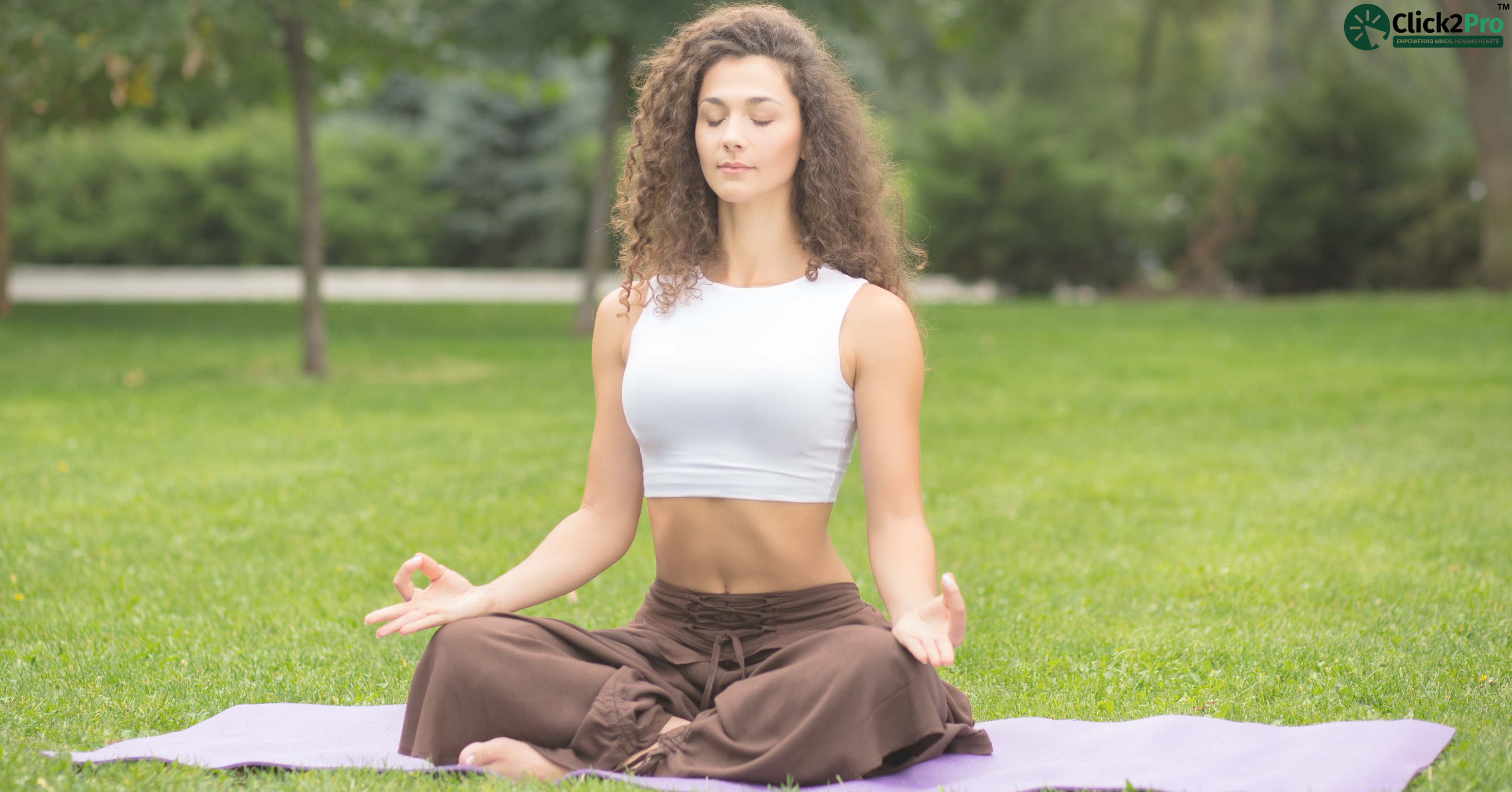 Woman practicing guided grounding meditation for stress relief in a peaceful outdoor setting.