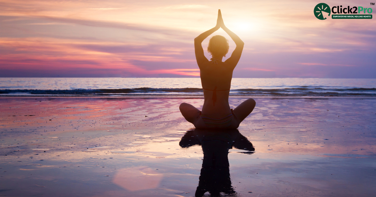 Child practicing mindful breathing at sunset by the beach, reducing anxiety through relaxation techniques.