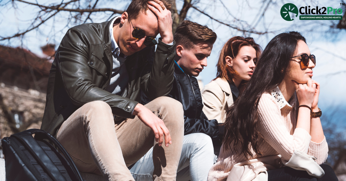Group of young adults sitting together, reflecting stress and peer pressure's impact on mental health.