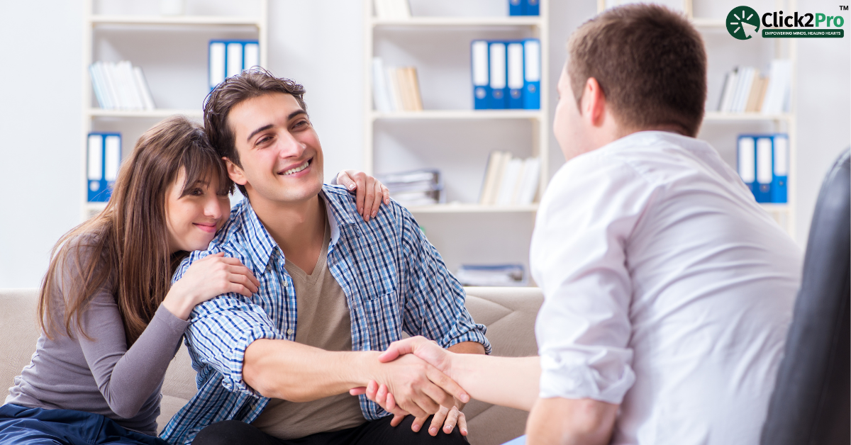 Happy couple in pre-marriage counseling session, shaking hands with therapist at Click2Pro office.