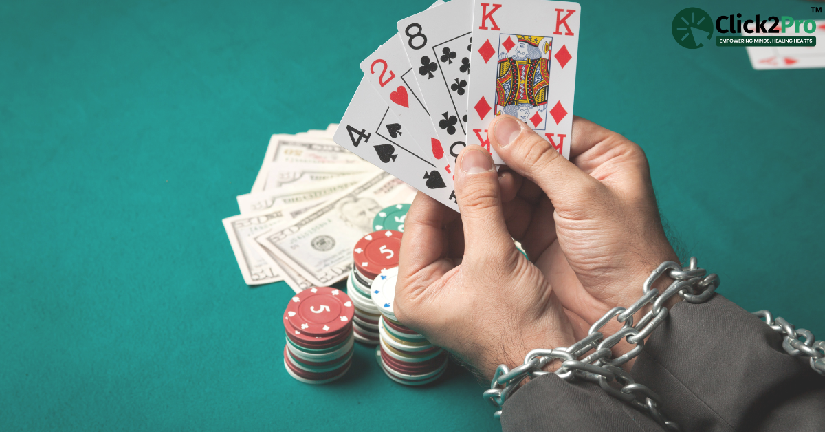 Hands chained holding playing cards with poker chips and money on a table, symbolizing gambling addiction.