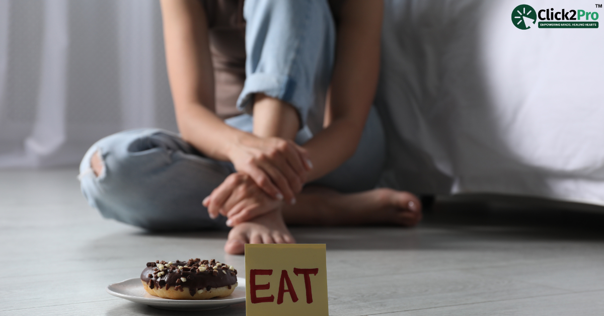 Person with an eating disorder sitting on the floor near food, illustrating CBT treatment for eating disorders.
