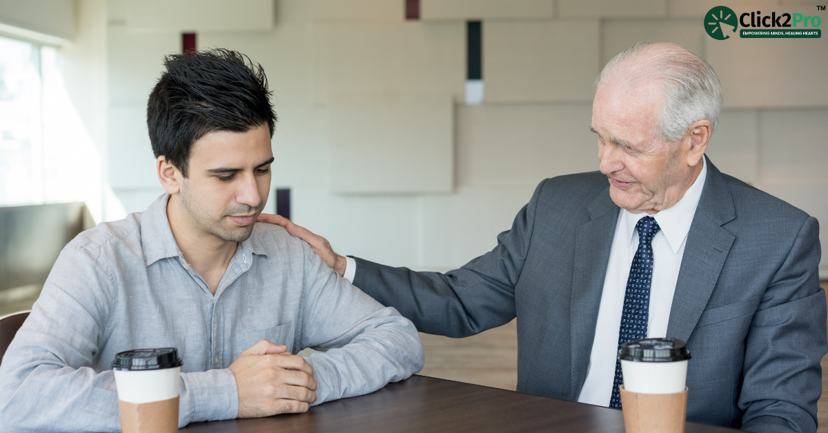 Young adult receiving support from an older man, symbolizing mental health guidance and care.