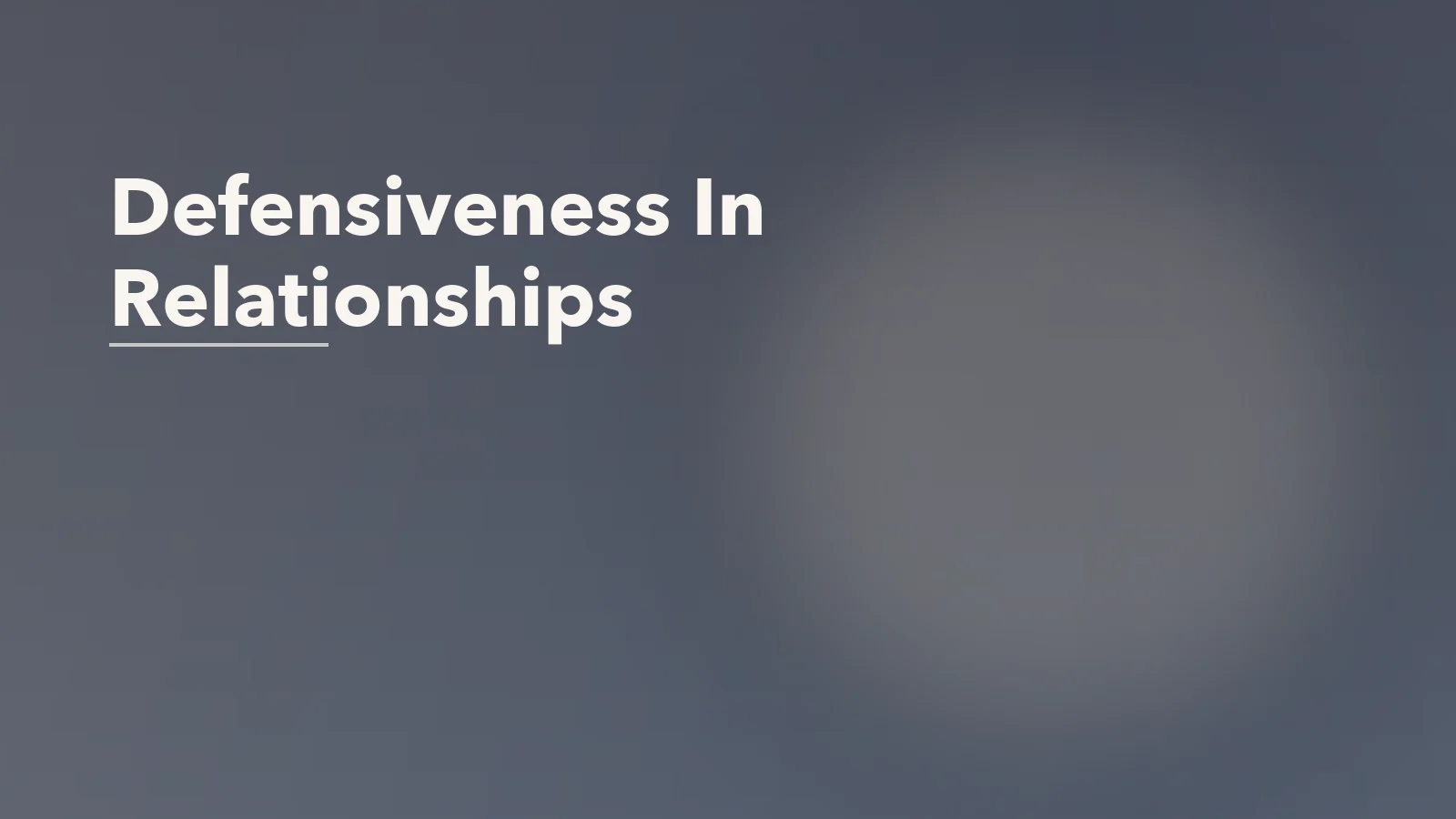 Editorial blog cover with the words 'Defensiveness In Relationships' for an article about how defensiveness quietly damages intimacy.