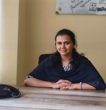 Female psychologist at desk providing confidential therapy sessions at Click2Pro